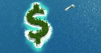 Yacht in wide open water approaching a dollar sign shaped island