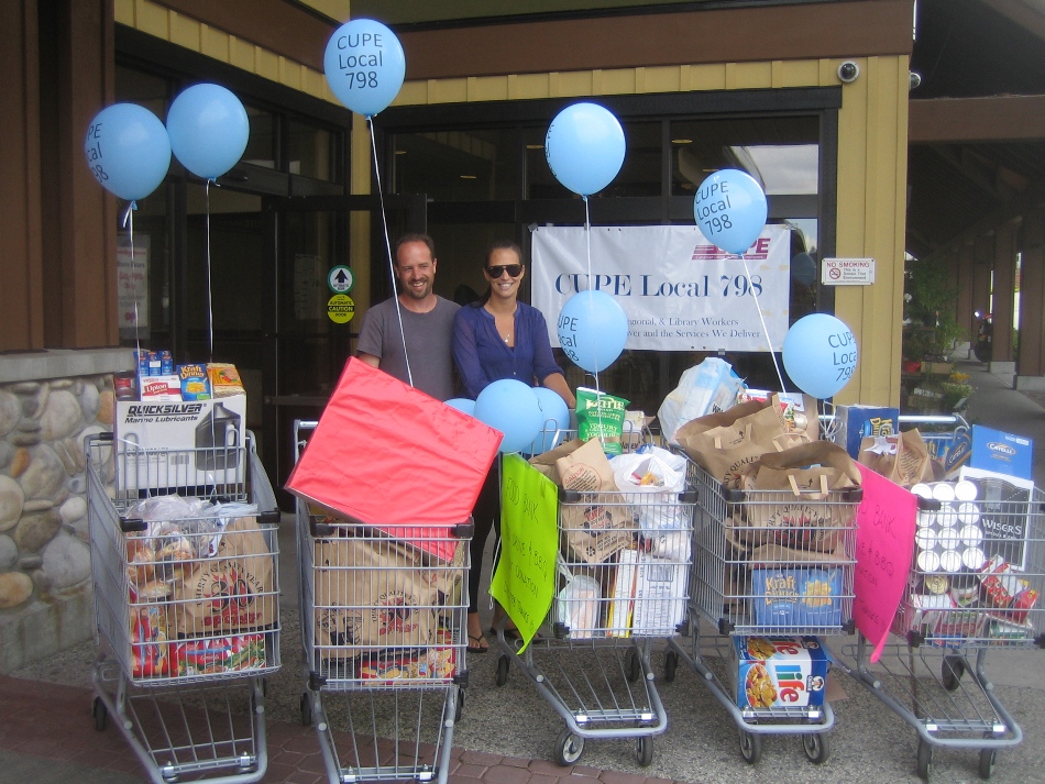 BIG HEARTS, BIG HAUL - CUPE 798 secretary-treasurer Graham Mahy and city payroll clerk Gaye Ross pose with some of the food donated at Saturday's event.