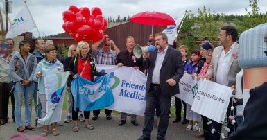 Mark Hancock speaks through megaphone at rally