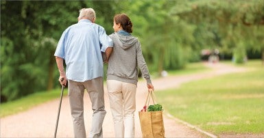 Senior father and daughter walking