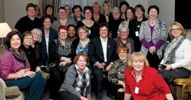 Large group of women sitting and standing for a group photo