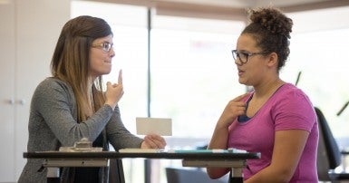 Female speech therapist helping a teenager