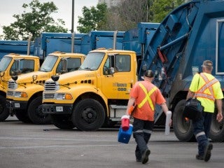 Toronto solid waste removal trucks and workers