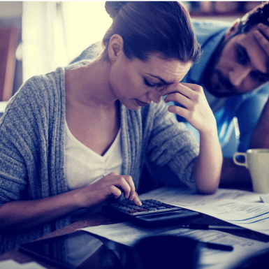 Couple looking at bills in kitchen