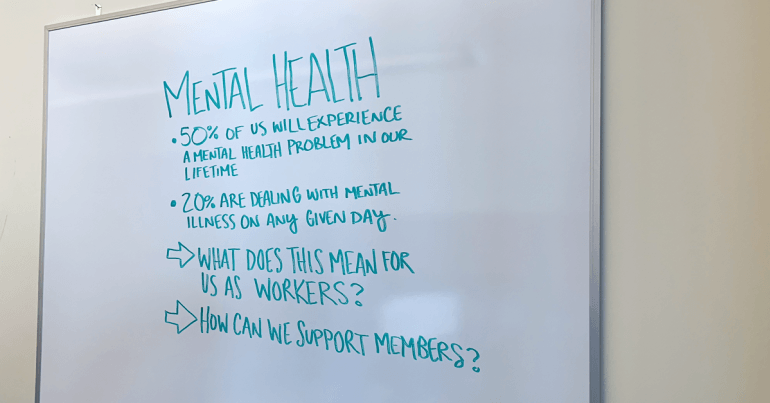 Writing on whiteboard about mental health