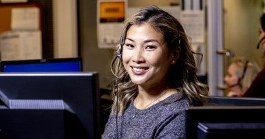 Smiling woman wearing a telephone headset