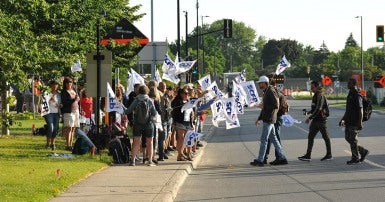 Striking workers holding SCFP flags