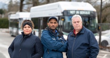 CUPE 561 transit operators in front of a not in service bus