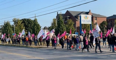 Striking workers holding picket signs