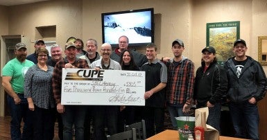 Image of group of people from CUPE 255 holding a giant cheque