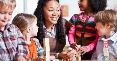 Education worker in classroom with children