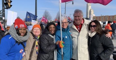 Group of CUPE Ontario activists standing together with flag
