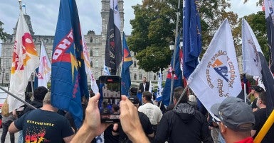 Photo of flags at a CUPE rally against energy privatization
