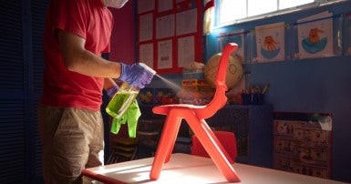 School custodian cleaning a chair