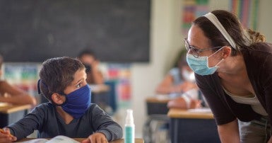 teacher and student with masks