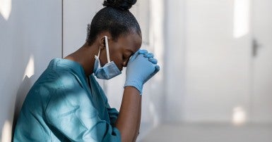 nurse resting head on hands