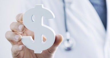 Doctor holding a dollar sign
