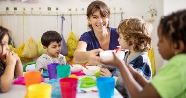 Image: Child care worker with children