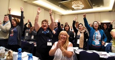 HEU convention delegates react to live-streamed announcement that punitive health worker legislation will finally be repealed.
