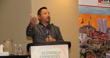 Image of Wes George standing at a lectern