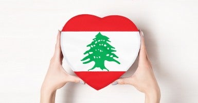 Female hands holding a heart shaped box bearing the Lebanese flag