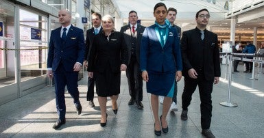 Flight attendants walk through airport