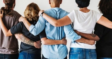 Diverse group linking arms together