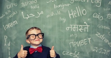 Child learning languages on chalkboard