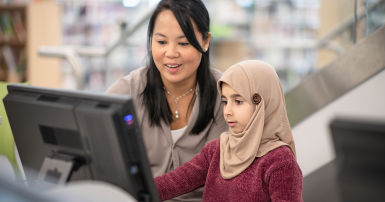 woman at computer with a child