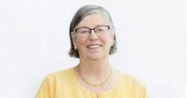 Smiling woman in a yellow shirt