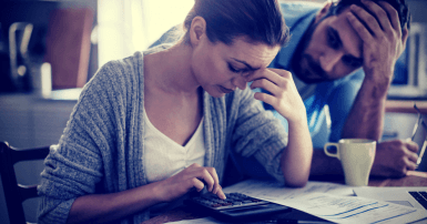 Couple looking at bills in kitchen