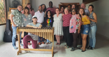 Group of people posing for a photo with some musical instruments 