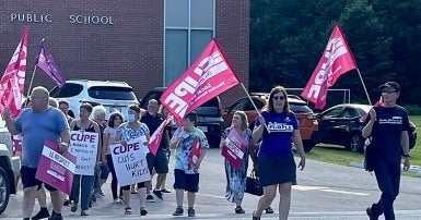 CUPE members rally in front of a public school