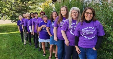 Education workers wearing purple shirts