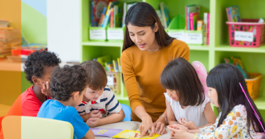 Teacher talking to kids in classroom