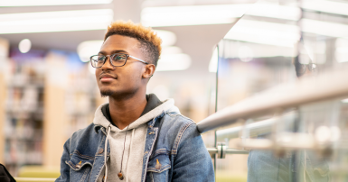 An African American University Student Studying in the Library