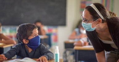 teacher and student with masks