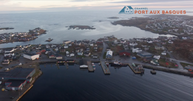 Aerial photo of Channel-Port aux Basques, NL, with a the town's text logo superimposed on the photo.
