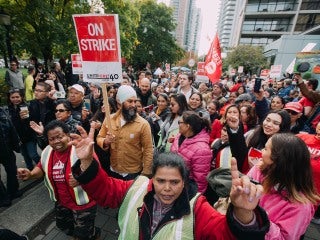 NDP Leader Jagmeet Singh in a crowd of picketers