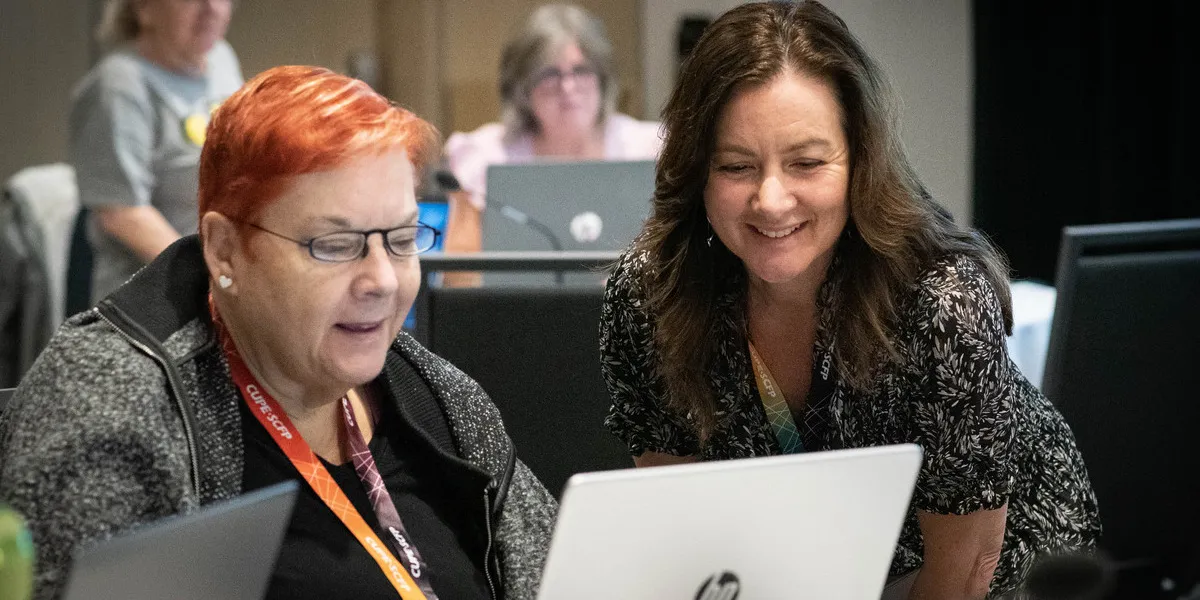 CUPE members at a laptop