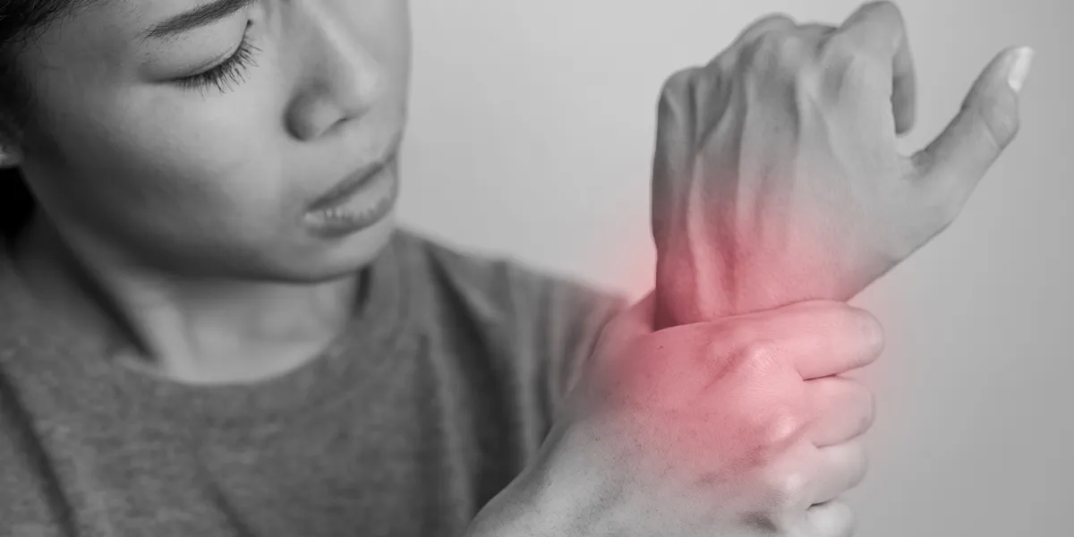 Focus on a wrist with a mark indicating pain