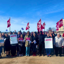 People standing with flags and picket signs