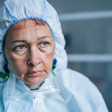 Tired Frontline health care Worker with protective suit during COVID-19