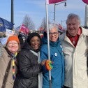 Group of CUPE Ontario activists standing together with flag