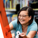 Photo of a smiling female library worker with text that says Library workers bring your library to life!