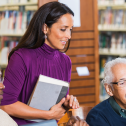 Library worker helping patrons