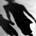 Shadow of woman and girl holding hands