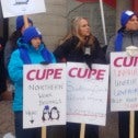 Group of women in winter clothing holding CUPE signs