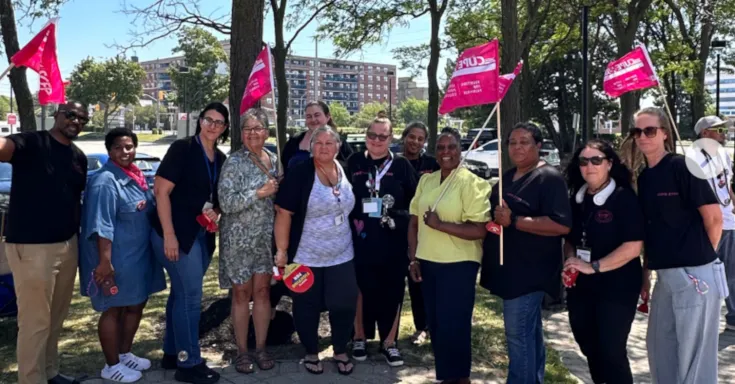 CUPE 2190 members outside holding CUPE flags