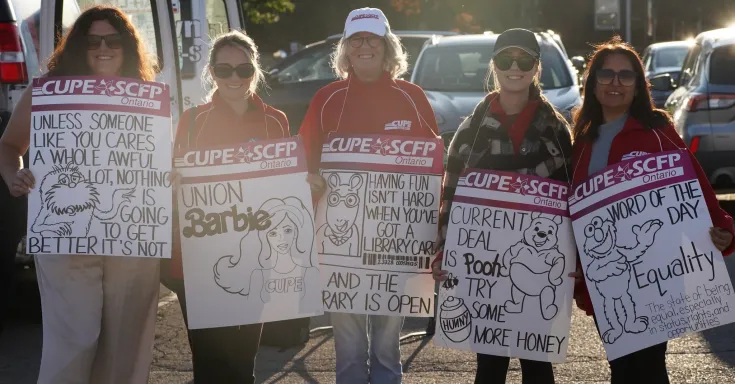 Women standing with picket signs